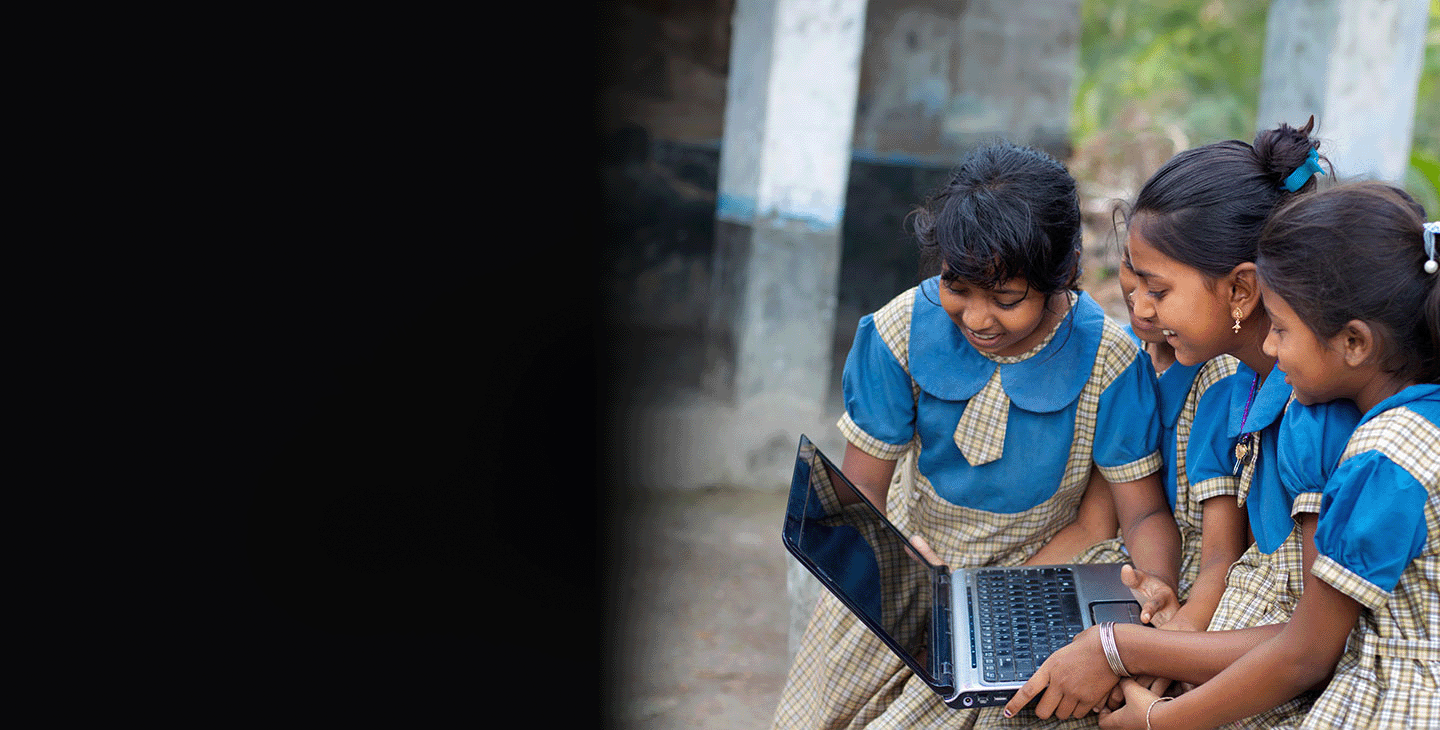 Children in a remote village using a laptop for school